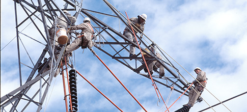 Lineworkers on transmission structure