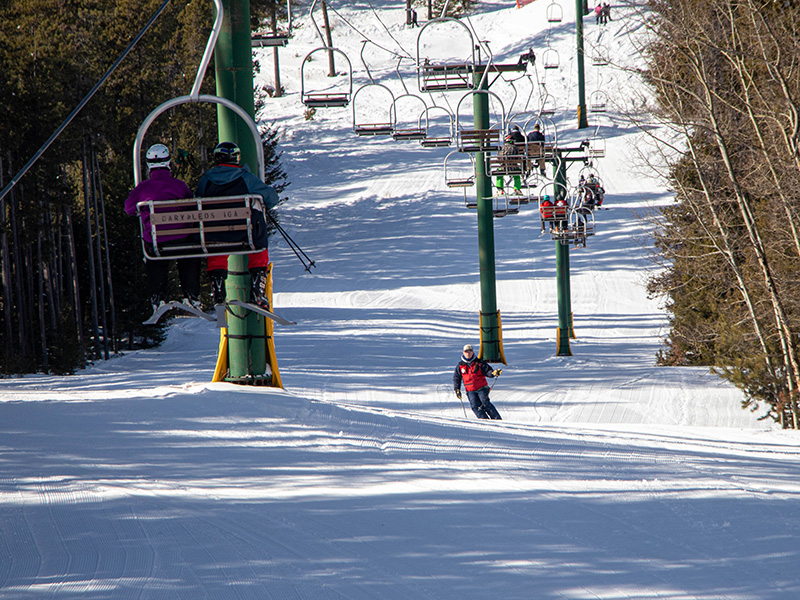 Skiers riding the chair lift