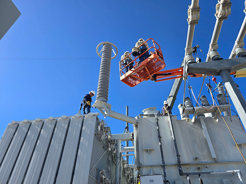 Employees decommissioning a transformer