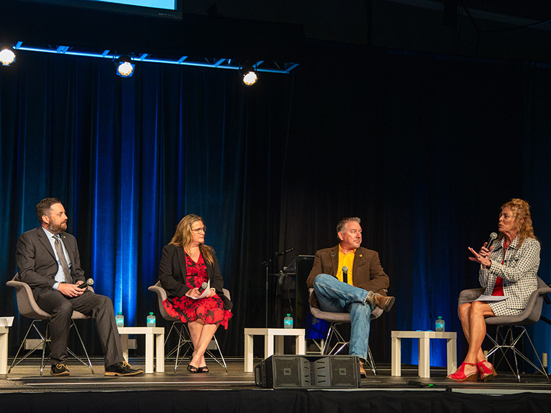 Panelists and moderator talking on stage