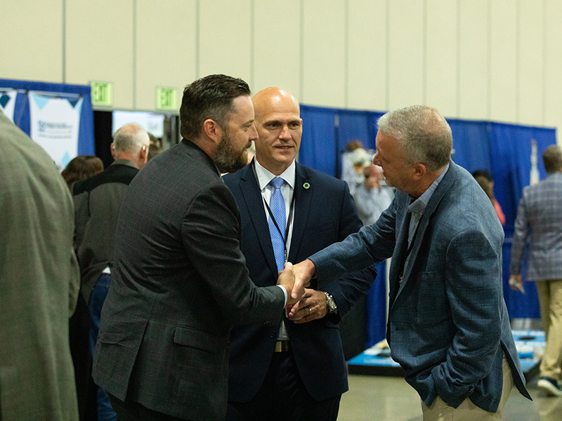 Members shaking hands at Annual Meeting