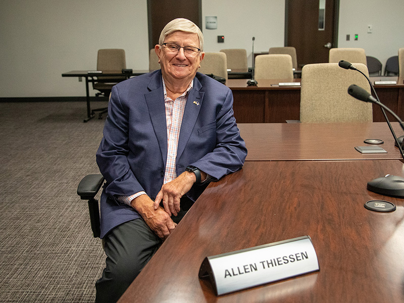 Allen Thiessen sitting in the Basin Electric board room