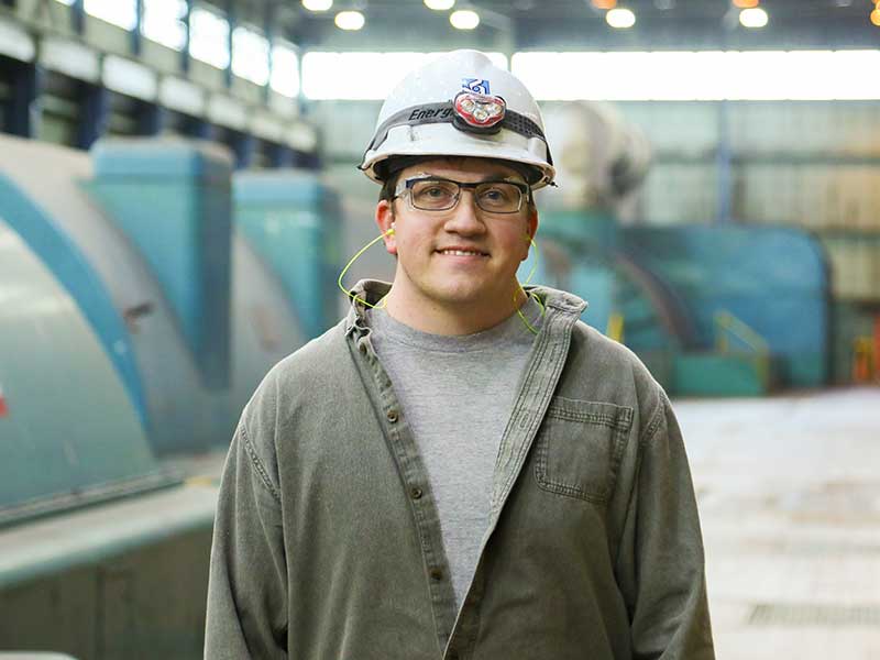 Man standing in generator room.