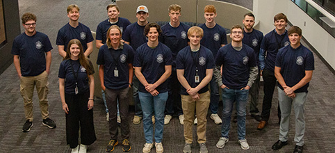 Interns in matching blue tshirts that say Your Energy Starts Here