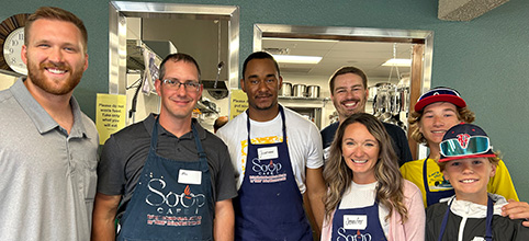 Group of employees volunteering at a soup kitchen