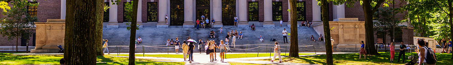 Students on campus in front of large building