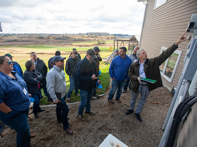 Energy audit class attendees tour a residential home.