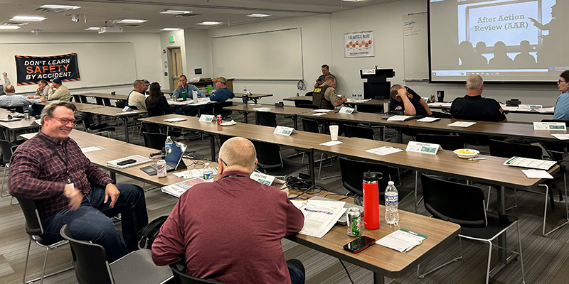 Attendees at the safety training discussing the exercise in a training room.