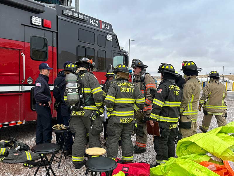 Firefighters gather around fire truck